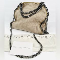 Stella Mccartney -Condition: Brand New Item With Original Tags Attached + Dust Bag + Card. -All Of Our Items Are 100% Authentic. -Dimensions: Length 10" X Height 11" X Width: 4". -Strap Drop: 21" X Top Handle Drop: 5". -Color: Natural (Beige / Grey). -Style Code: 371223 -Model: Stella Mccartney Falabella. -Material: (Tessuto Lino) Linen. -Silver-Tone Hardware. -Pink Satin Lining With Interior Pocket. -Open Top With Magnetic Closure. -Made In Italy. -Retails For $1,205.00 -Item Ships Out Within 2 Designer Chain Shoulder Bag For Travel, Chic Gray Shoulder Bag With Dust Bag, Designer Shoulder Bag With Chain For Travel, Everyday Luxury Beige Shoulder Bag With Chain Strap, Gray Chain Strap Bag For Everyday, Luxury Shoulder Bag With Chain For Shopping, Luxury Beige Shoulder Bag With Chain, Stella Mccartney Falabella Mini Outfit, Luxury Beige Shoulder Bag With Chain Detail