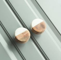 two wooden knobs on the side of a door