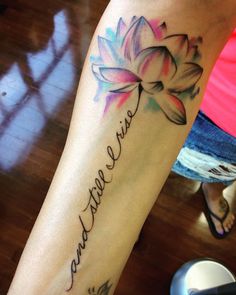 a woman with a tattoo on her arm that says, i love you and has a flower in it