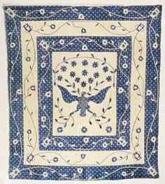 a blue and white wall hanging with a butterfly design on it's center piece