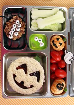 a lunch box with some food in it and eyes on the side, including bread