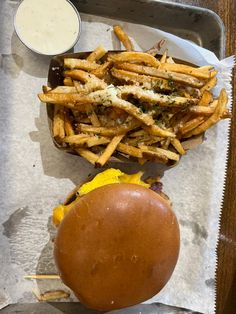 a burger and fries are on a tray