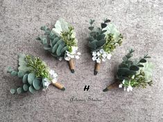 four boutonniers with flowers and greenery are arranged on the floor