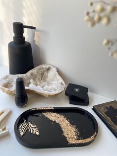 various items are arranged on a white counter top, including a soap dispenser