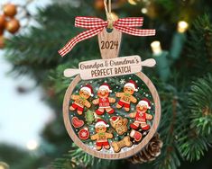 a christmas ornament with gingerbreads and santa hats hanging from a tree