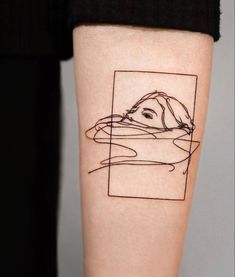 a woman's arm with a tattoo on it that has a dog in the water