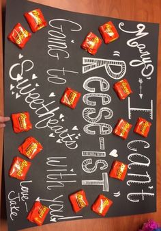 a chalk board with candy bars on it