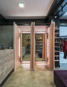 the inside of a clothing store with open doors