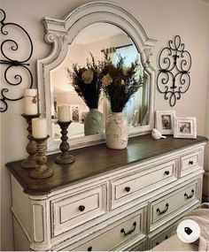 an old dresser with flowers and candles on top is featured in the instagram page