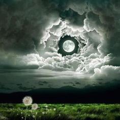 an image of a full moon in the sky with clouds and green grass below it