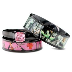 two wedding bands with pink and black camo inlays, one has a princess cut diamond