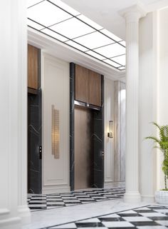 an elegant bathroom with marble floors and black and white tiles on the floor, along with two elevators