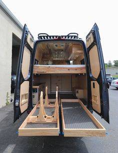 the back end of a van with its doors open and two wooden steps up to it