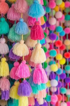 many colorful tassels hanging from the ceiling