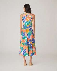 Floral printed cotton sleeveless midi sundress. This style features shoulder ties, a curved neckline, a fitted bodice with interior boning, and a full A-line midi skirt with side seam pockets. Bodice lined, skirt unlined. Hidden back zipper. 97% Cotton, 3% Spandex. Dry clean only. Color: Sunburst Multi Spring A-line Midi Dress With Tie Straps, Vacation A-line Midi Dress With Tie Back, Unlined A-line Midi Dress For Summer, Casual A-line Midi Dress With Tie Straps, Unlined Midi Dress For Summer, Multicolor Midi Length Dress With Tie Straps, Multicolor Midi Dress With Tie Straps, Summer A-line Maxi Dress With Tie Waist, Sleeveless Multicolor Tropical Print Midi Dress