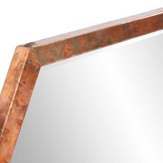 a mirror that is made out of wood and metal with a brown pattered frame