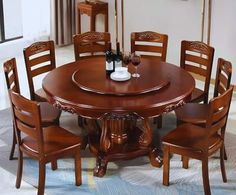 a dining room table and chairs with wine bottles on the top one is set for six