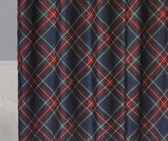 a bathroom with a shower curtain that has a plaid pattern on it