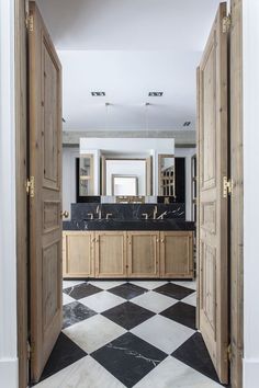 an open door leading to a bathroom with black and white checkerboard flooring