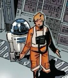 a man in an orange jumpsuit is standing next to a star wars machine and looking at the camera