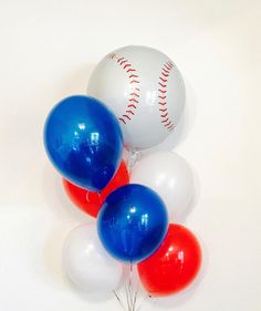 three baseball balloons with red, white and blue balls