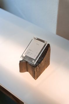 an electronic device sitting on top of a wooden block