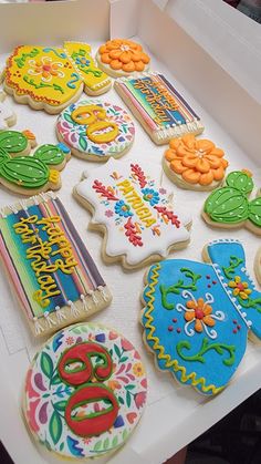 decorated cookies in a box on a table