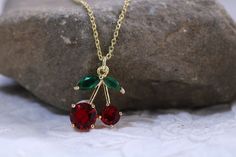 Gold filled red green rhinestone cherry charm pendant necklace with matching earring option. Dainty minimalistic cherry necklace ,and ,or earring set High quality 18k gold plated  With adjustable chain - Length option of 14'' to 16'' ,or 16'' to 18''  chain. Dainty minimalistic pendant charm. Great as a gift ,or for yourself for that special occasion! Any questions feel free to ask! Thanks for supporting a small family run business! Comes packaged in a beautiful box ready to gift! Elegant Cherry Colored Jewelry For Party, Red Cherry Print Jewelry For Gifts, Elegant Cherry Colored Necklace For Gift, Elegant Cherry Color Necklace For Gift, Handmade Cherry Jewelry For Party, Handmade Cherry Jewelry For Gift, Minimalistic Pendant, Cherry Charm, Cherry Necklace