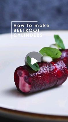 a white plate topped with beetroot covered in green leafy garnish