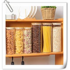 a shelf filled with lots of different types of cereals and pasta in glass jars