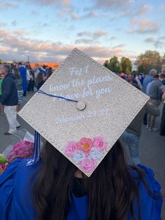 a person wearing a graduation cap with writing on it