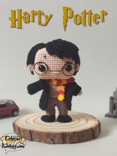 a small harry potter doll on top of a tree stump