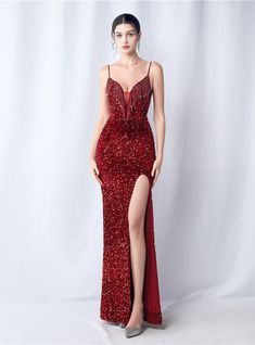 Featuring a splendor that rivals the fiercest fire, the gown is a cascade of sequins that catch every flicker of light. This prom dress is an embodiment of passion, crafted for those who command the spotlight with ease and elegance. The entirety of the dress sparkles with dense, red sequins, creating a texture thatboth visually stunning and delightful to the touch. Its fitted silhouette is complemented by the fluidity of the high slit, marrying movement with a statuesque quality. The delicate straps and refined neckline are designed to flatter, leading the gaze to the intricate detailing of the bodice. This dress doesn't just make an entrancet makes a statement of intent, one of unforgettable impact and enduring charm. Ruby Red Prom Dress, Minimalistic Accessories, Statement Of Intent, Sequin Halter, Minimalist Accessories, Mermaid Sequin, Backless Prom Dresses, Red Prom, Red Sequin