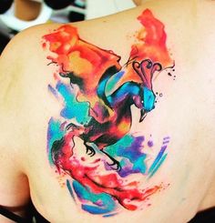 a woman with a colorful tattoo on her back