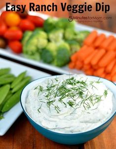 a bowl of dip surrounded by vegetables and carrots with the words easy ranch veggie dip