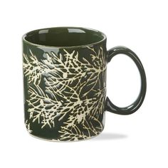 a black and white mug with gold snowflakes on it