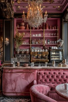 a fancy pink bar with chandelier hanging from the ceiling