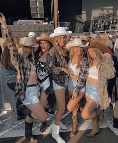 several women in cowboy hats posing for a photo