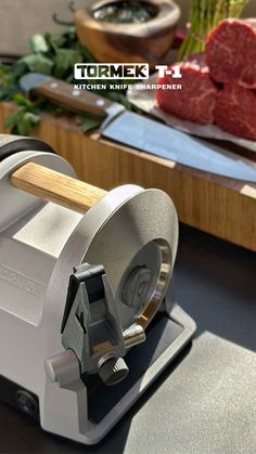 a meat slicer sitting on top of a cutting board next to other food items