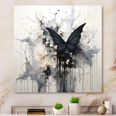 an abstract painting with black and white butterflies on it's wings in front of a fireplace