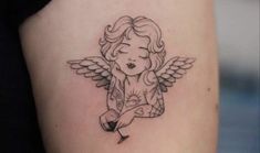 a small angel tattoo on the left side of the right arm, with an arrow at the bottom