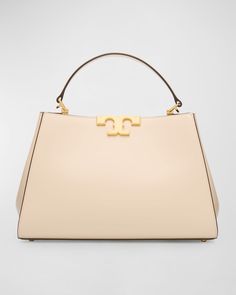 Tory Burch "Eleanor" satchel bag in leather     Top handle    Detachable, adjustable shoulder strap    Can be worn as a top handle or shoulder/crossbody bag     Open top with magnetic closure     Divided interior     Lining: Polyurethane    Feet protect bottom of bag     Approx. 8.3"H x 12.6"W x 8.3"D    Imported High-end Handheld Satchel With Handles, High-end Shoulder Satchel, High-end Tan Bag With Detachable Strap, Designer Satchel With Detachable Handle, Timeless Satchel With Handles For Shopping, Modern Tan Satchel Shoulder Bag, Designer Tan Top Handle Shoulder Bag, Luxury Tan Satchel With Double Handle, Designer Handheld Satchel With Detachable Strap