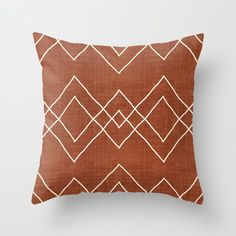 a brown and white pillow sitting on top of a wall