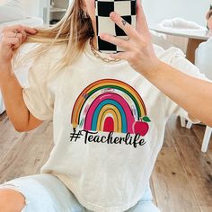 Teacher Life  Shirt, Inspirational Teacher Shirts,Teach love, Back To School, First Grade Teacher Shirts, Teacher Appreciation Tee Shirt  : 100% Cotton (fiber content may vary for different colors) .: Medium fabric (5.3 oz/yd² (180 g/m .: Classic fit .: Runs true to size HOW TO ORDER Pick you favorite design. Review the size & color charts above FIRST and then select shirt size and color from the dropdown menu. Indicate the birthday year in the personalization box. Please note size measurements Fun Short Sleeve Tops For Teaching, Casual Short Sleeve Shirt For Teaching, Casual Tops With Text Print For Teaching, White Relaxed Fit Top For Teaching, Casual Relaxed Fit Tops For Teaching, White Cotton T-shirt For Teaching, White Cotton T-shirt, Cute Rainbow Print Cotton T-shirt, Rainbow Letter Print Cotton Tops