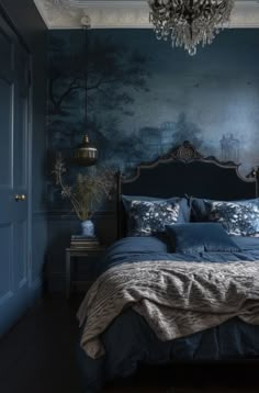 a bedroom with blue walls and a chandelier hanging from the ceiling above the bed