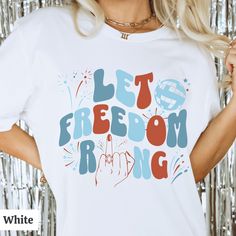 a woman wearing a white t - shirt that says let's freedom ring