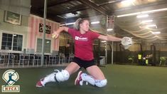 a woman in red shirt and black shorts holding a ball