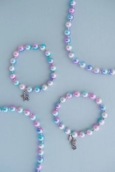 This set of 2 bracelets is perfect for any under the sea adventure or everyday mermaid wear. Featuring purple and blue beads and two metal pendants. A fun sea horse and a detailed star fish. Make sure to grab the matching necklace for double the fun! Find matching mermaid mist necklace, here! Dimensions: 9x7x1cm Mermaid Craft, Pulseras Aesthetic, Mermaid Accessories, Mermaid Kids, Sea Adventure, Mermaid Crafts, Packaging Jewelry, Metal Pendants, Stretchy Beaded Bracelet