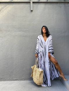 "\"Uluwatu Kaftan dress\" Soft, Smooth, Lightweight Rayon voile Fabric. Perfect for Elegant Day and Nightwear or worn as a cover-up for that beach or poolside statement of glamour. And for Muslim women Color - Hand Tie Dyed White & Black Measurements in CM and Inches. Size American measurement Medium to Large. It fits to all the body size between M to2XL Size - One size fits all American size From S to 2XL Total wide /240cm/94inch(round) Chest & him /180cm/70inch(round) The length /150cm Bohemian V-neck Kaftan For Vacation, Flowy V-neck Kaftan For Day Out, Hippie V-neck Free Size Maxi Dress, Flowy Boho Sundress For Beach Cover-up, Casual Maxi-length Kaftan For Vacation, Boho Print Maxi Length Cover-up For Festivals, Free Size V-neck Maxi Dress For Beachwear, White Free Size Maxi Dress For Beach Cover-up, Bohemian Long Sleeve Kaftan For Day Out