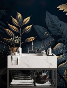 a bathroom sink sitting under a mirror next to a wall with leaves painted on it